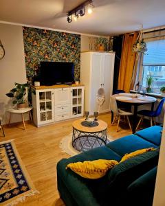 a living room with a blue couch and a table at Apartament Boho in Inowrocław