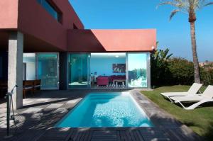 a villa with a swimming pool and a house at Salobre Villas in Salobre