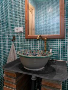 a bathroom with a sink and a mirror at Casa Canela in Órgiva