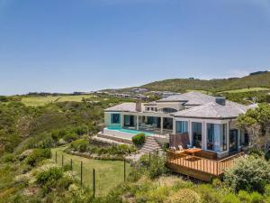 an aerial view of a house with a view of the ocean at Super Beachfront views- Executive Villa - 6 bedrooms in Knysna