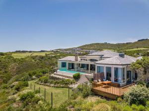an aerial view of a house with a view of the ocean at Super Beachfront views- Executive Villa - 5 bedrooms in Knysna