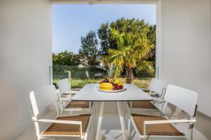 a dining room with a table and chairs and a window at Cocoοns Suites & Villas Fourka in Fourka