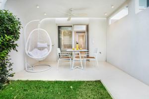 a patio with a table and chairs and a window at Cocoοns Suites & Villas Fourka in Fourka