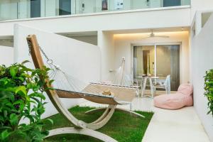 a hammock in the garden of a house at Cocoοns Suites & Villas Fourka in Fourka