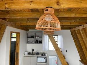 a light hanging from a wooden ceiling in a kitchen at Portal Dos Campos in Ponta Grossa