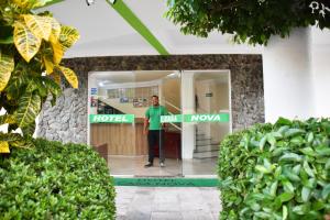 a man standing in the doorway of a hotel at Hotel Casa Nova in Várzea Grande