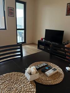 a table with two remote controls on top of it at Apartment with Sea View in Varna City