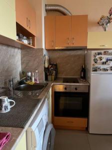 a kitchen with a sink and a stove top oven at Apartment with Sea View in Varna City