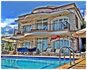a house with a swimming pool in front of it at Villa Valo in Kalkan