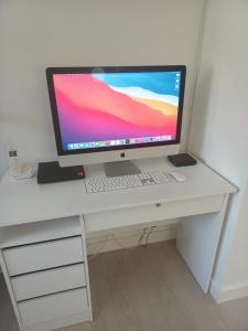 a desk with a computer monitor and a keyboard at Best Experience Tours Centre in Tours