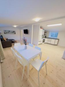 a white table and chairs in a living room at aday - Holiday Apartment in the heart of Frederikshavn in Frederikshavn