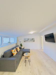 a living room with a couch and a table at aday - Holiday Apartment in the heart of Frederikshavn in Frederikshavn