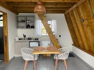 a dining room with a wooden table and chairs at Pousada Portal Dos Campos in Ponta Grossa