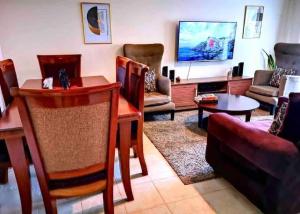a living room with a couch and a table at Gem in Busia