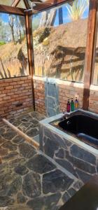 a bathroom with a stone floor and a sink at Mitanni in Santa Isabel