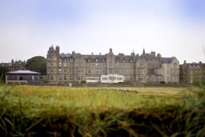 a large building with a grass field in front of it at Marine North Berwick in North Berwick