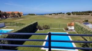 a view from the balcony of a house with a swimming pool at Holiday Calm Villa - Beach & Pool in Atouguia da Baleia