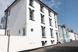 a white building on the side of a street at 10a East Cliff in Southwold