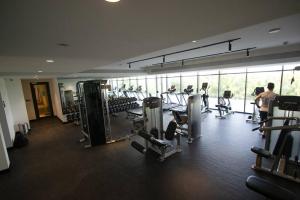 a gym with cardio equipment in a building at 45 Mins drive to Dubai Marina and The Beach at JBR in Sharjah