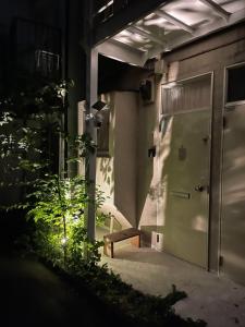 a building with a door and a bench in front of it at Kyodo's small room cottu - Vacation STAY 14595 in Tokyo