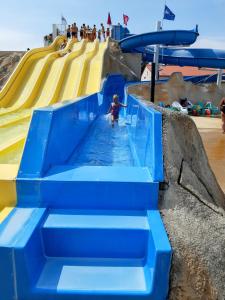 a child in a water slide at a water park at Les Charmettes - SIBLU in Les Mathes