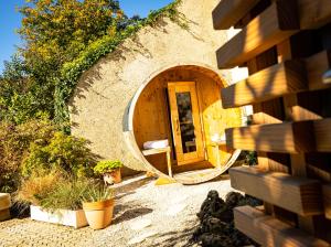 a circular building with a door in the middle at Logis Relais de la Source in Saint-Seine-lʼAbbaye