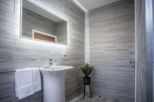 ein Bad mit einem Waschbecken und einem Spiegel in der Unterkunft Suite 15 - Sleeping Giant Hotel - Pen Y Cae Inn in Brecon