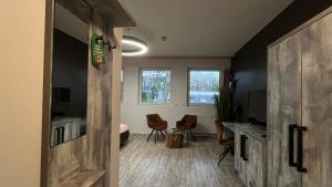 an open door to a room with a desk and chairs at VitaLounge Sports & Spa Hotel in Gelsenkirchen
