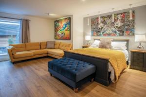 a bedroom with a bed and a couch at Suite 14 - Sleeping Giant Hotel - Pen Y Cae Inn in Brecon