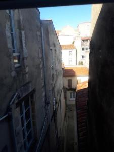 une vue sur une ruelle située entre deux bâtiments dans l'établissement ALEIDA, à La Rochelle
