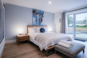 a bedroom with a bed and a large window at Suite 6 - Sleeping Giant Hotel - Pen Y Cae Inn in Brecon