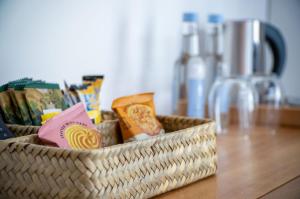 a basket sitting on a table with food in it at Suite 12 - Sleeping Giant Hotel - Pen Y Cae Inn in Brecon