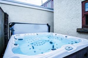 a bath tub sitting on the side of a building at Oak Lodge - The Sleeping Giant - Pen Y Cae Inn in Brecon