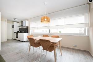 a kitchen with a white table and chairs at White Sea by Seasidehomes in Castelldefels