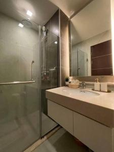 a bathroom with a glass shower and a sink at Luxury and modern condo in Central Chiang Mai - Astra Condo in Chiang Mai