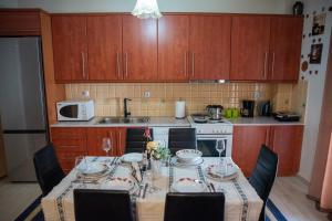 a kitchen with a table and chairs and a kitchen with a table at Peaceful House Stylida in Stilís