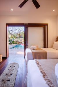 a bedroom with three beds and a swimming pool at Villa Messina Jeri in Jericoacoara +39 photos