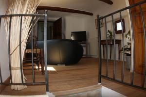 a living room with a large black orb in a room at La ferme de blanche in Entrechaux