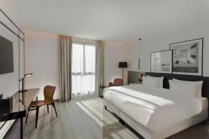 a hotel room with a large bed and a desk at Radisson Hotel Tunis, City Center in Tunis
