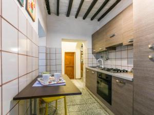 a kitchen with a table with two cups on it at Casa Zia Seconda in Montecatini Val di Cecina +16 photos