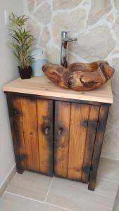 a bathroom sink with a wooden bowl on top of it at Apartment Tia Vis in Vis