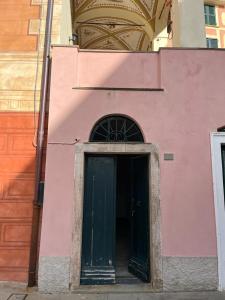 un edificio rosa con puerta verde en CASA MARIA ROSA - a pochi passi dal mare, en Bonassola