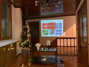 a christmas tree in a room with a screen at Ogeri76 in Mokpo