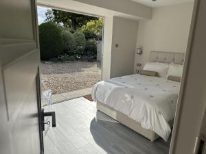 Bourne End的住宿－Beautiful 1-Bed Studio in Bourne end，一间卧室设有一张床,一扇门通往庭院