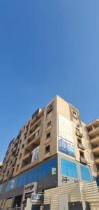 a tall building with a blue sky in the background at برج حورس in Obour