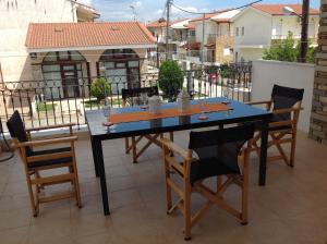 a blue table and chairs on a balcony at Neaktion Apartments in Nikiti