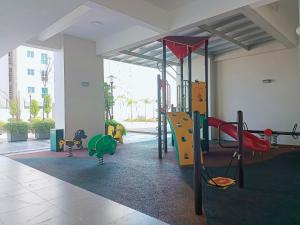 a play room with a playground with a slide at Harmony suites 1, 3-5 pax, Jelutong Georgetown Penang in Jelutong