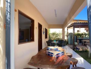 a living room with a table and a patio at Casa em Antunes Maragogi Condomínio Beira Mar in Maragogi