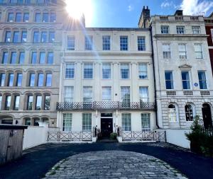 a large white building with the sun in the sky at Be London - The Lincoln's Inn Residences in London