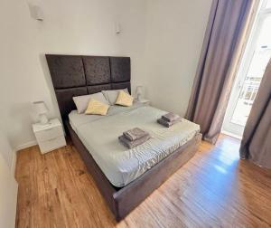 a bedroom with a bed with two towels on it at Central and modern Valletta flat in Valletta